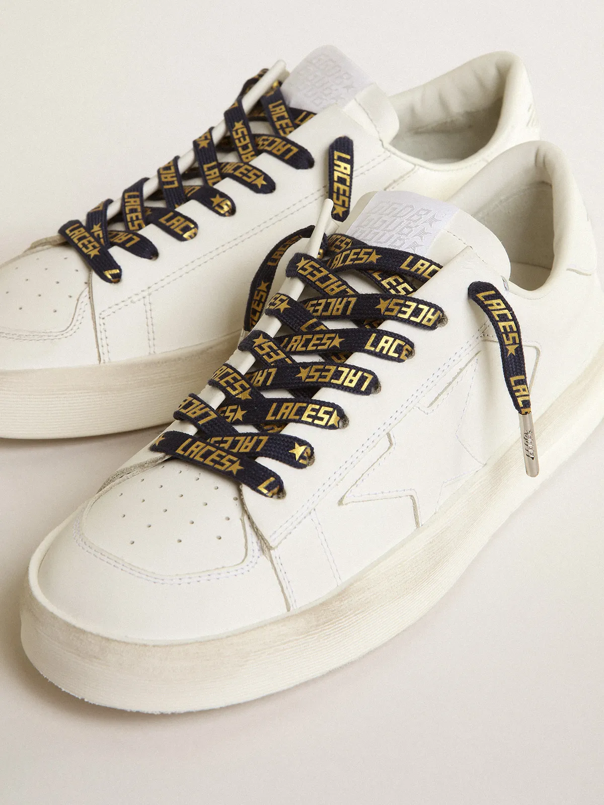 Navy-blue laces with contrasting gold-colored ‘Laces’ lettering